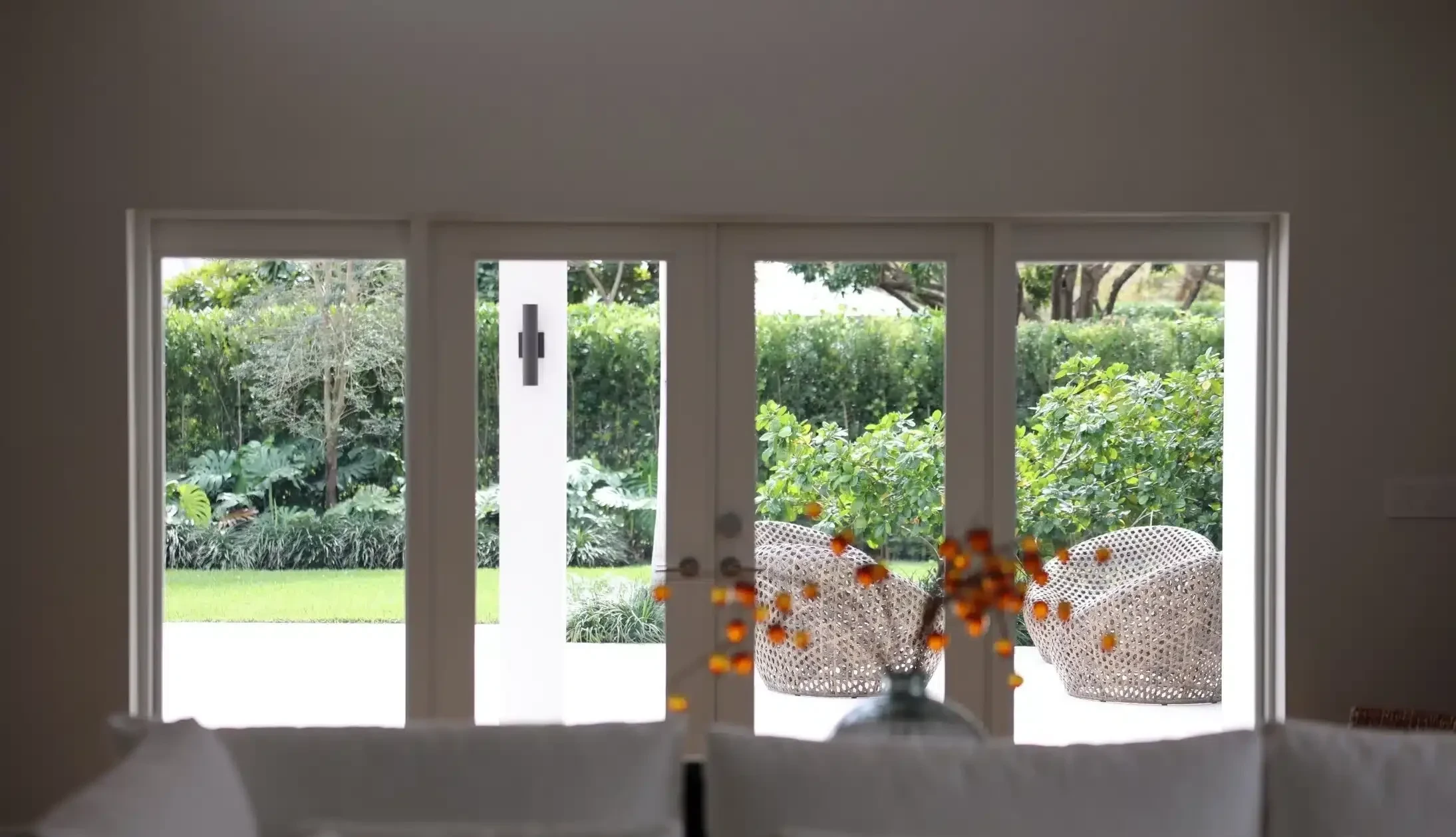 Garden-view impact windows and doors from a living room interior