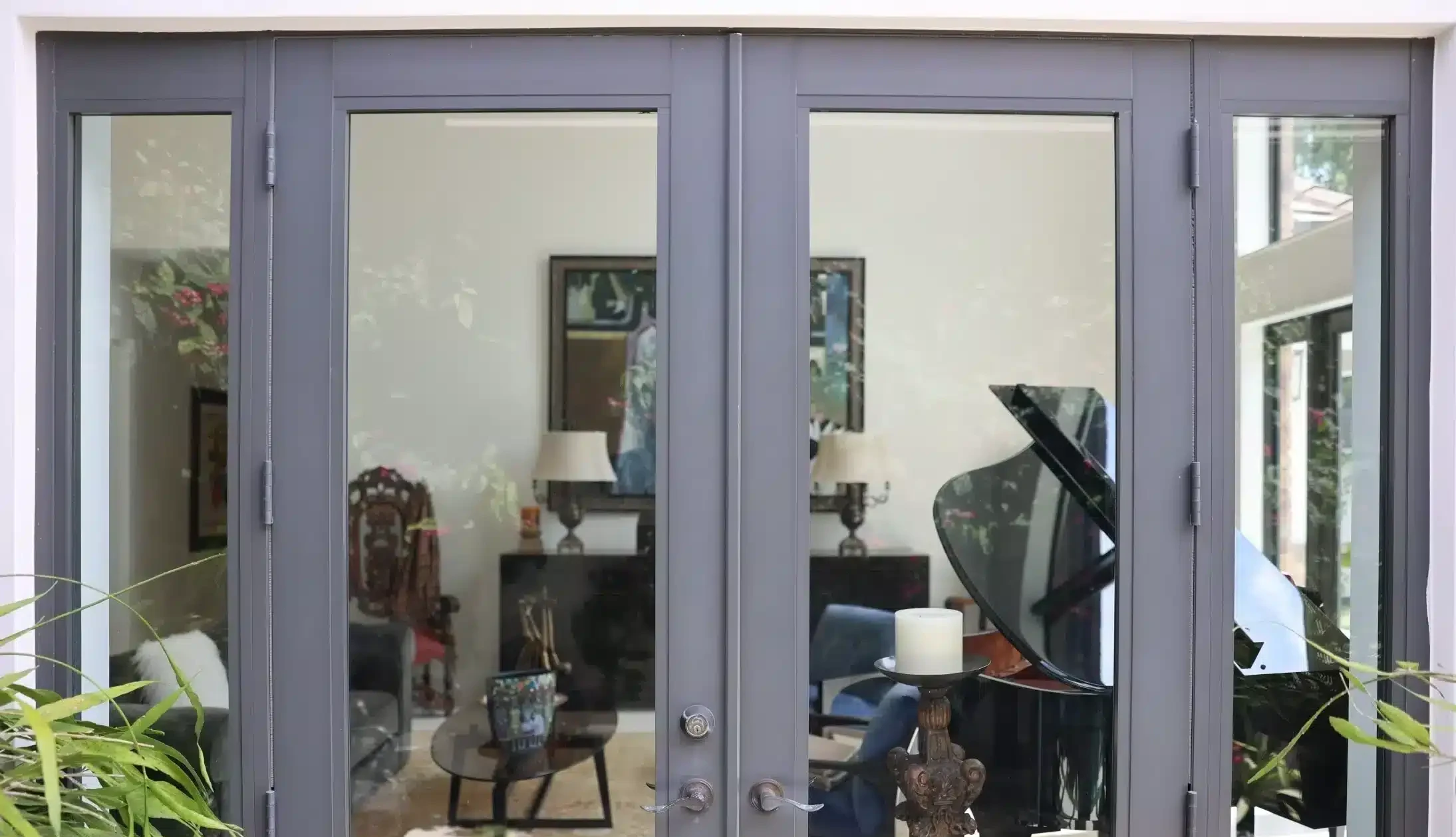 Gray-framed French doors opening to a living room