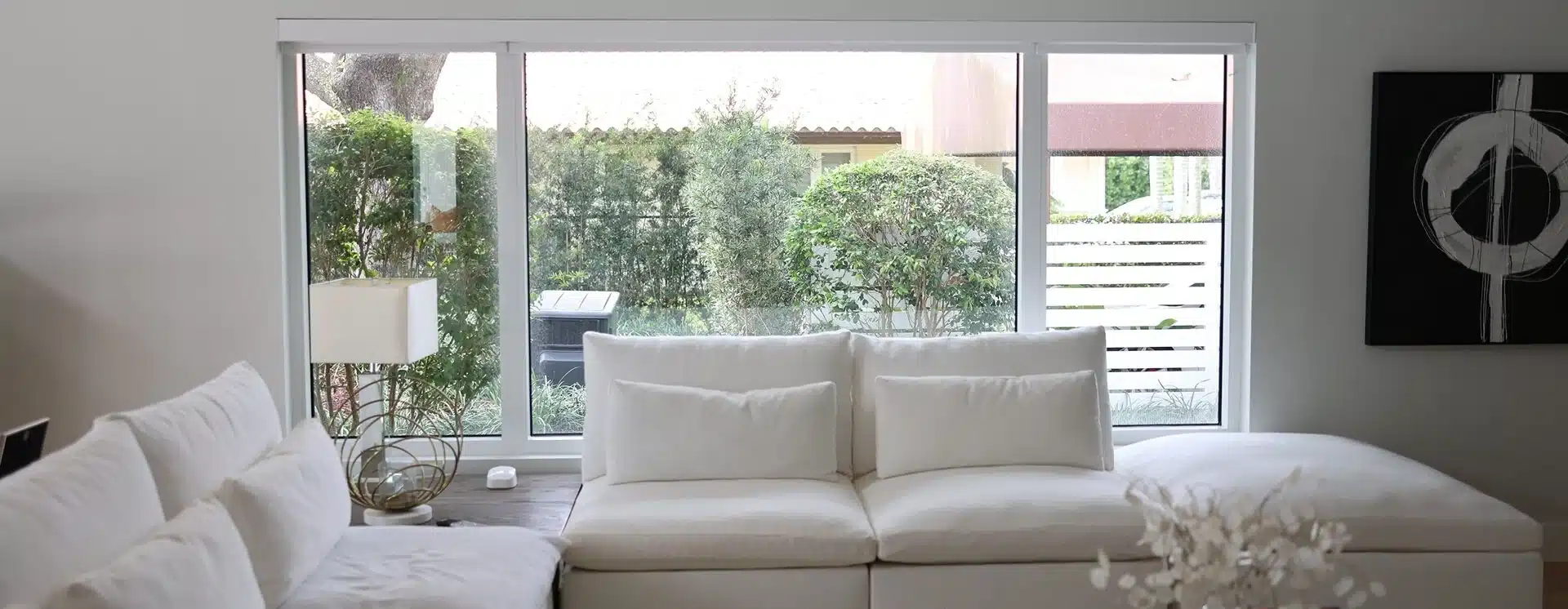 Bright living room with white-framed impact windows